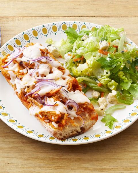 buffalo chicken french bread pizza on plate with salad