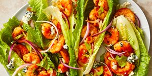 shrimp in buffalo sauce in lettuce wraps with blue cheese and red onions