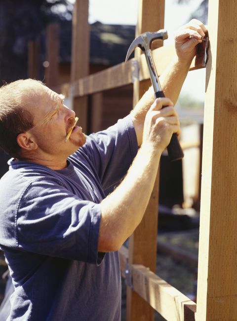builder hammering nail into framework