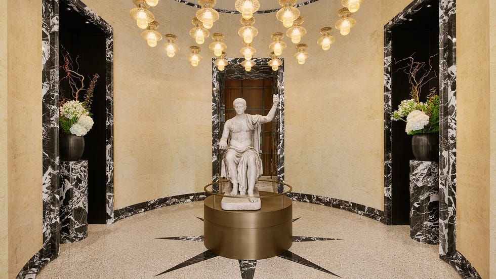 interior space featuring classical sculpture and decorative lighting