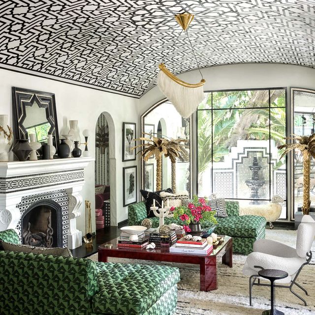 Living room with two green sofas and patterned domed ceiling
