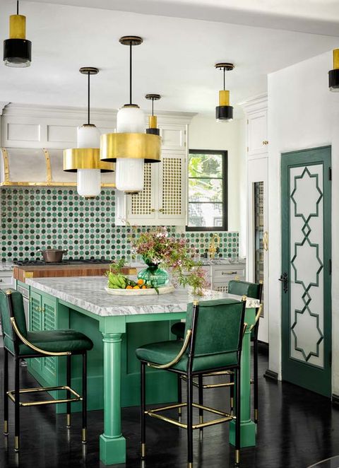 kitchen with marble counter and green cabinets, leather stools, and dark flooring