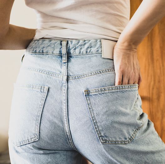 woman wearing jeans with her hand in back pocket