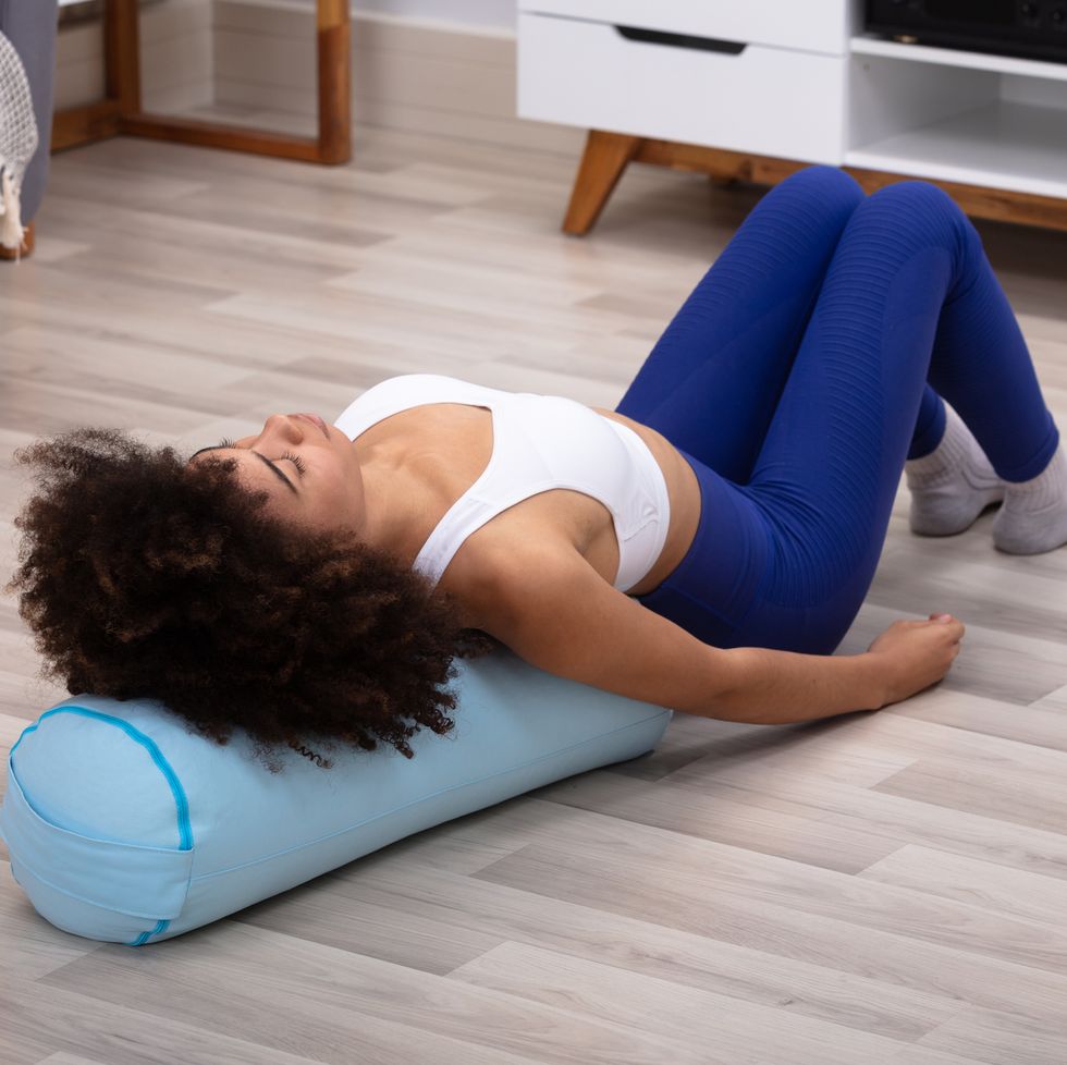 close up of a woman lying on pillow exercising doing pelvic floor exercises