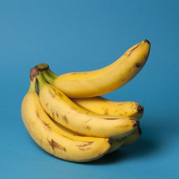 a bunch of bananas with one banana sticking up, suggestive of an erection