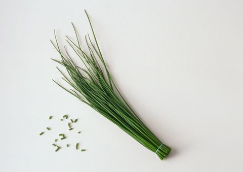 bunch of chives with cut chives, white background