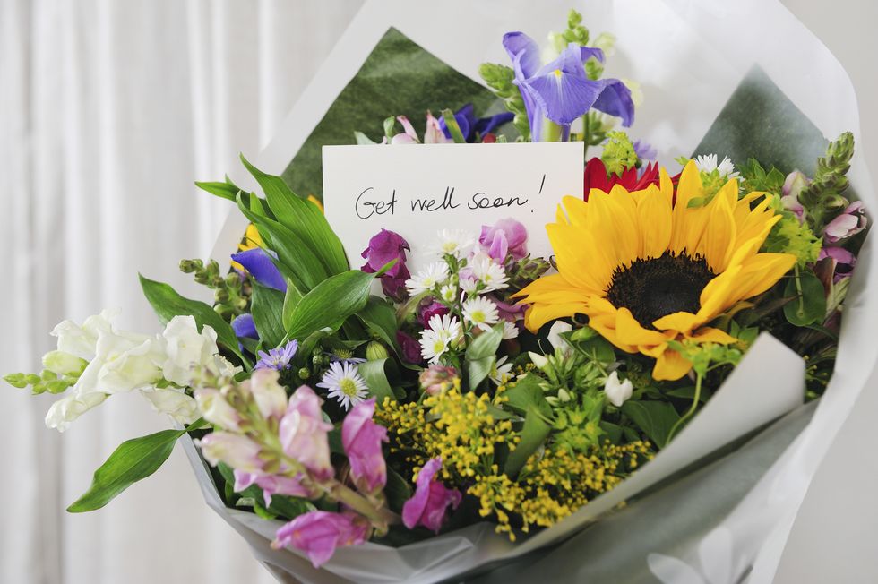 bunch of flowers with "get well soon" message
