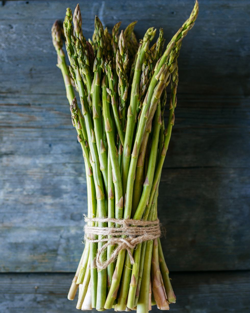 bunch of green asparagus on wood