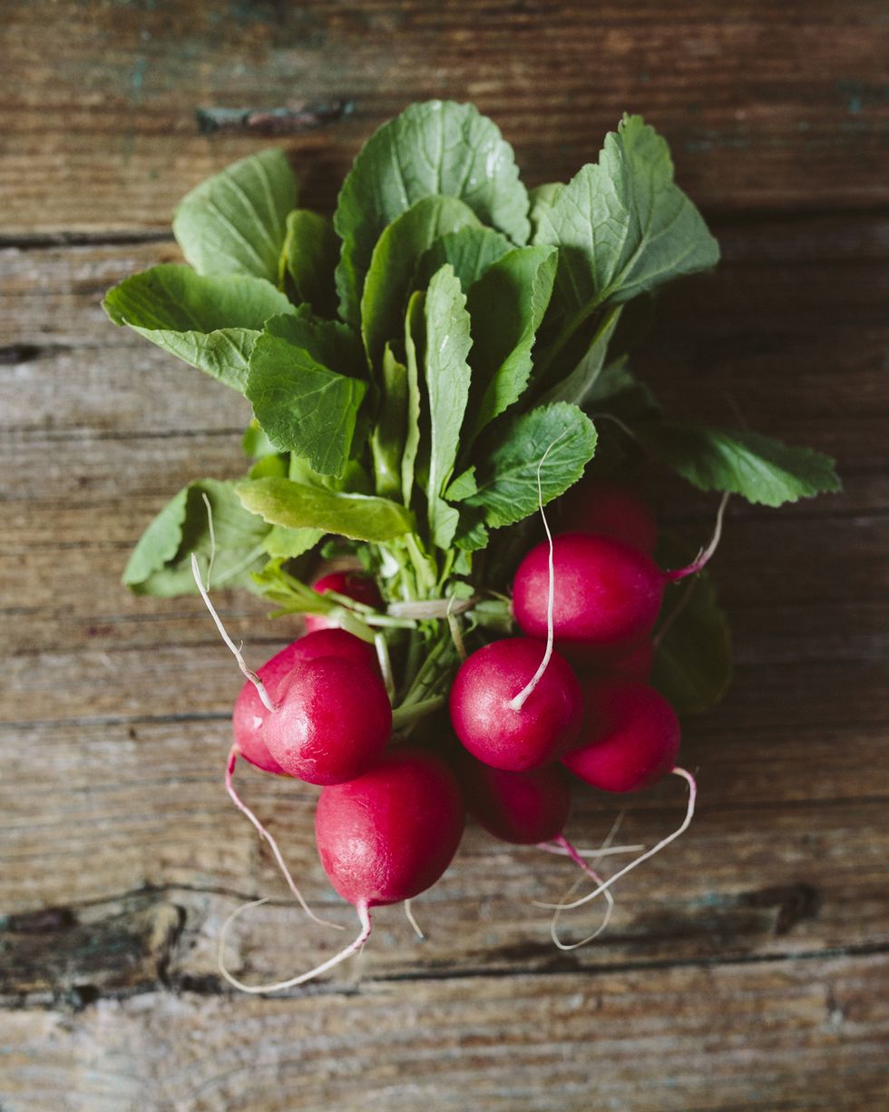 bunch of red radishes on wood