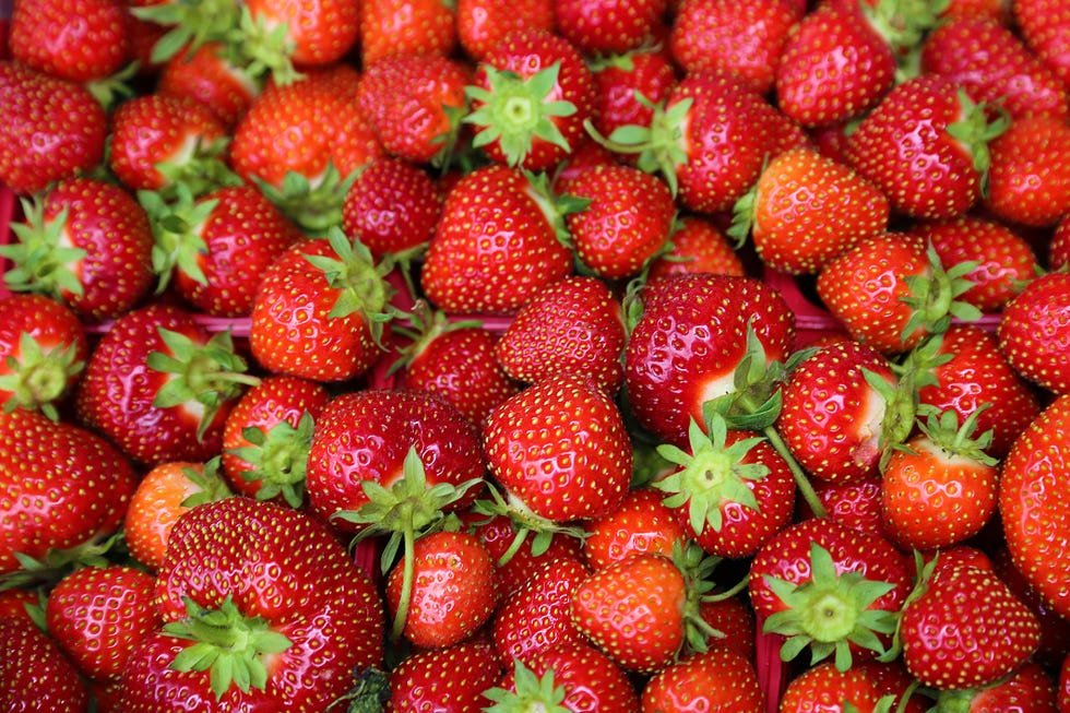 a bunch of strawberries, an ingredient in one of good housekeeping's best diy face scrubs