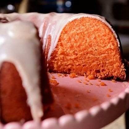 orange crush cake on pink cake stand