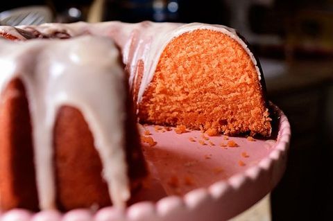 orange crush cake on pink cake stand