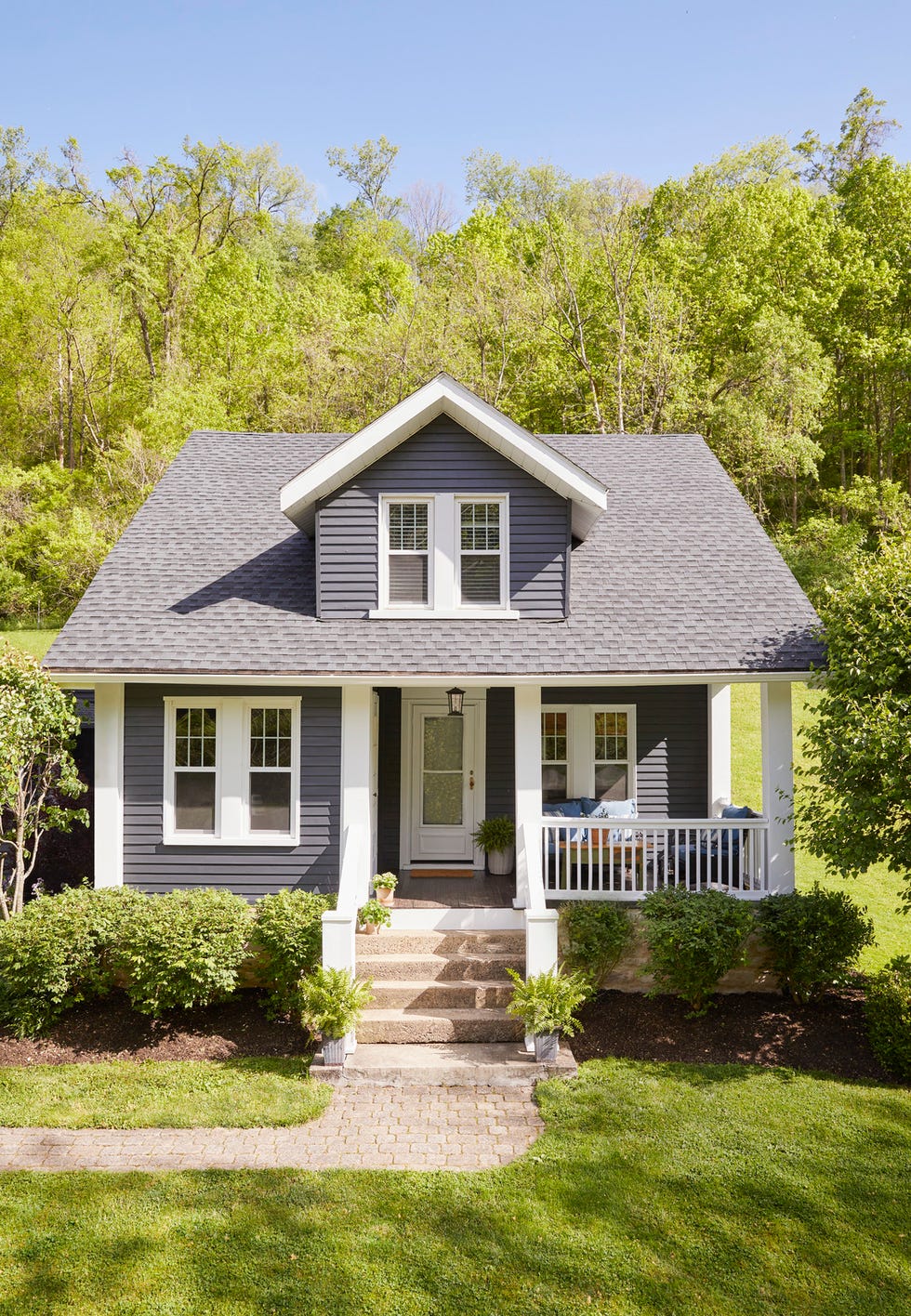 blue bungalow house with white window trim