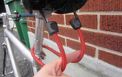 A bungie cord on a bicycle. 