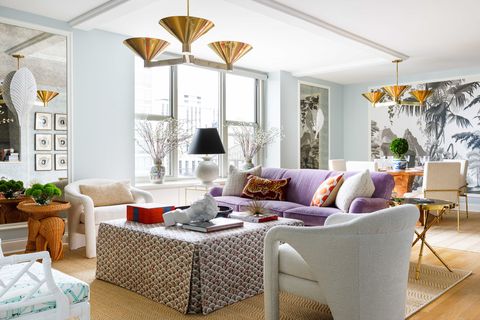 purple couch, living room, light blue painted walls, white sofa chairs, gold hanging pendants
