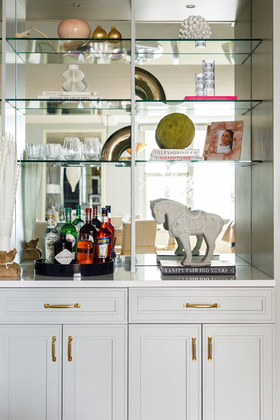 bar, white cabinets, gold hardware, mirror