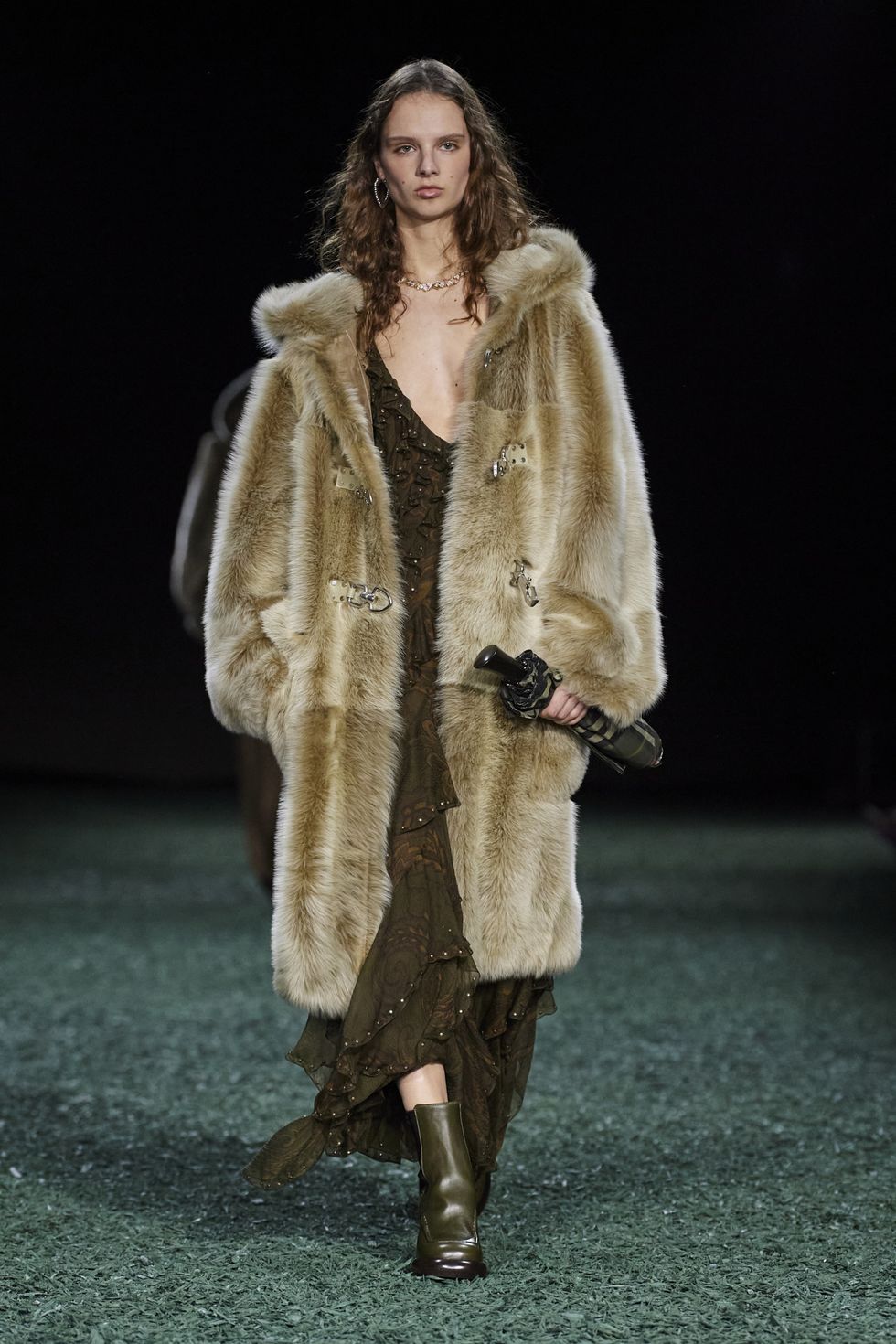 a person wearing a fur coat and boots