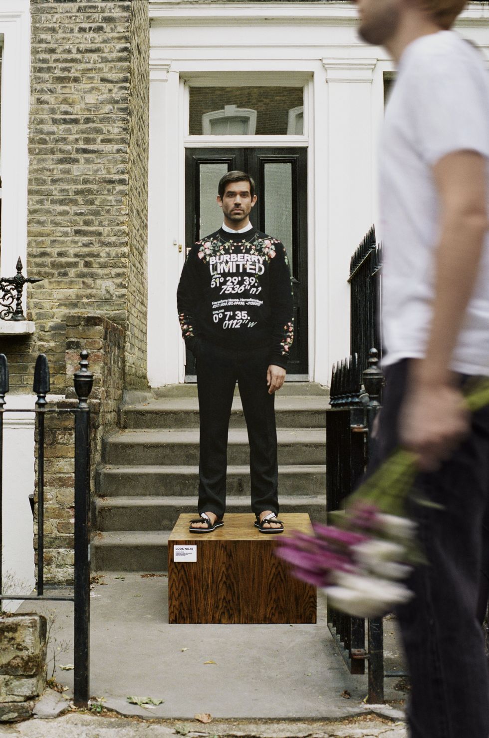 burberry員工穿著英倫玫瑰圖案黑色衛衣於家門前拍攝