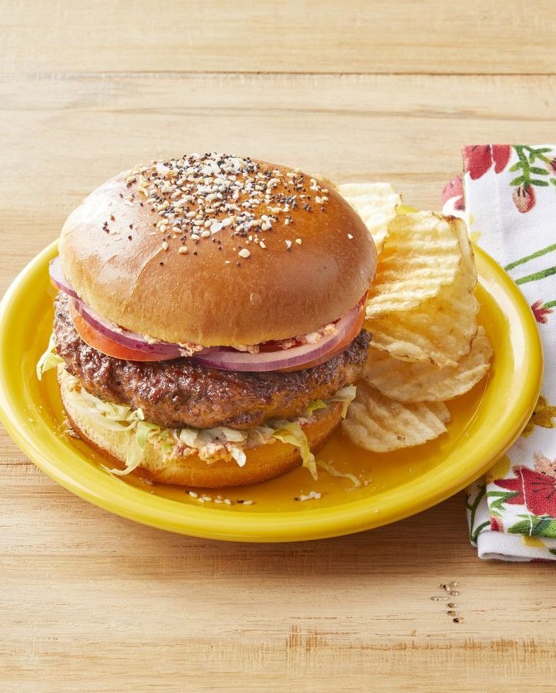 everything burgers on yellow plate with chips