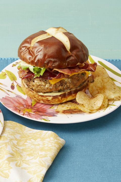 ranch turkey burgers with bacon and cheddar on pretzel bun with chips on side