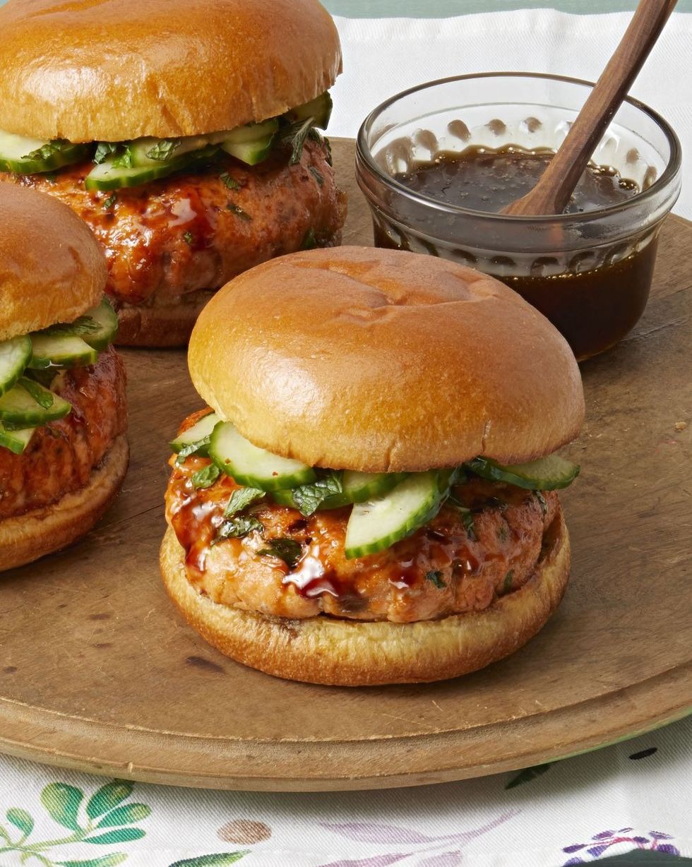 salmon burgers with glaze and cucumbers on buns