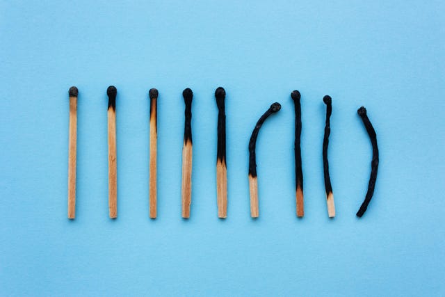 burned matches in a row on a blue background