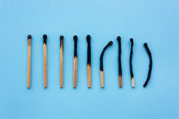 burned matches in a row on a blue background