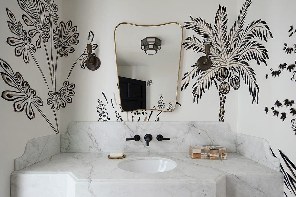 a bathroom with a large mirror and wallpaper a bathroom with a large mirror and wallpaper