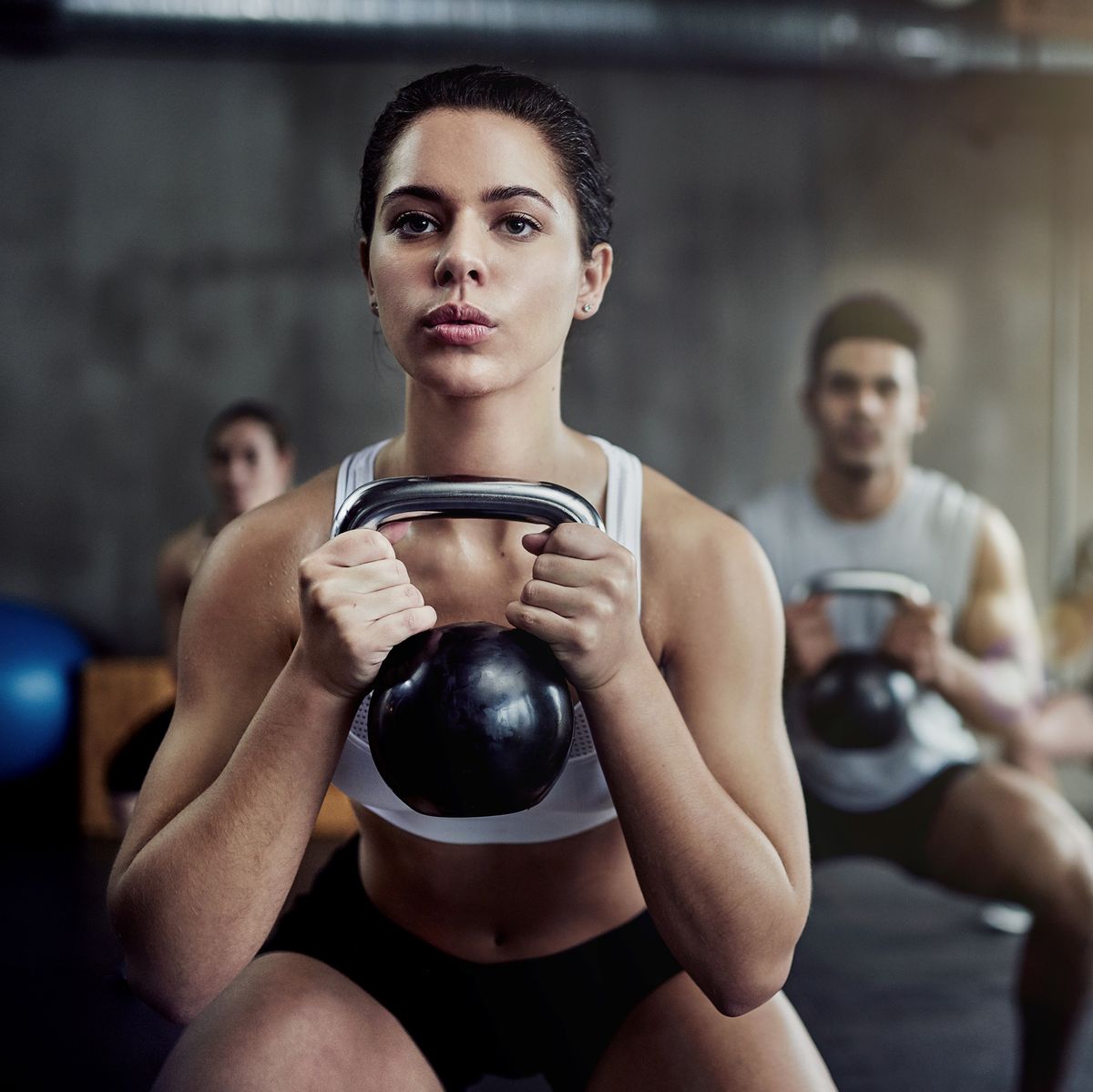 Burning calories and strengthening her core with a kettlebell