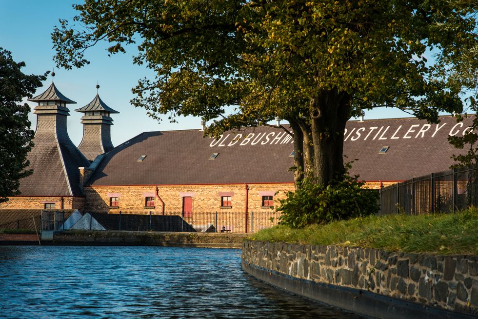 old bushmills distillery next to the river brush