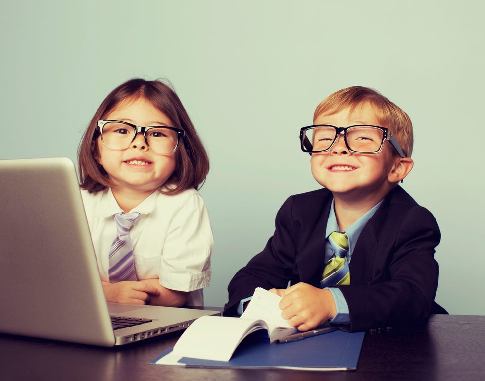 two kids dressed up in work clothes pretending to be at a corporate job