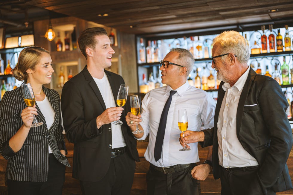 business people having fun talking and discussion with while drinking champagne at business success party