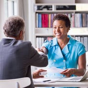Business people shaking hands at desk Business people shaking hands at desk