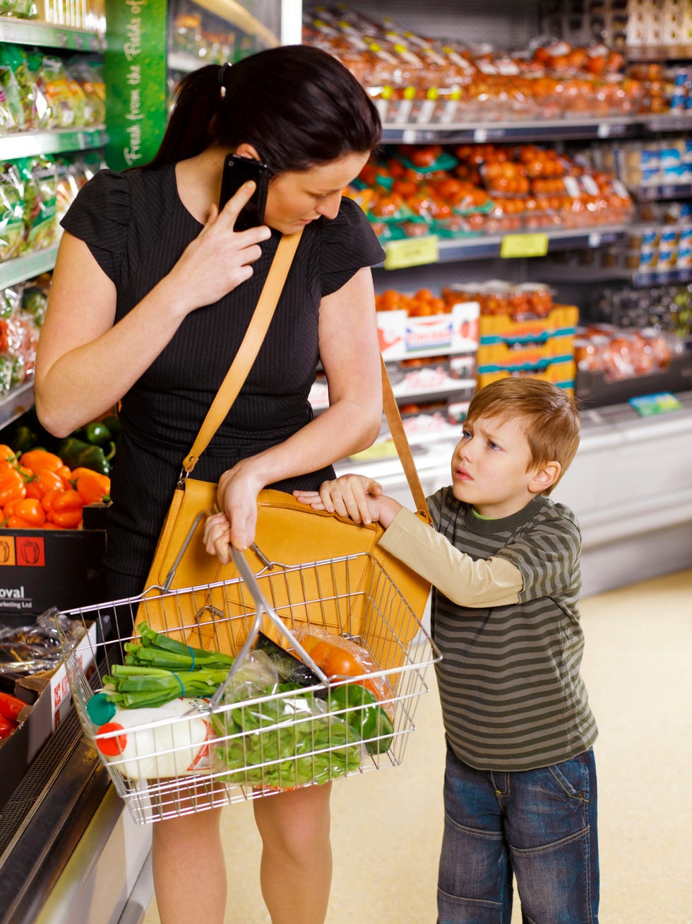 business woman shopping with unhappy son