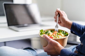 businessman having salad in office