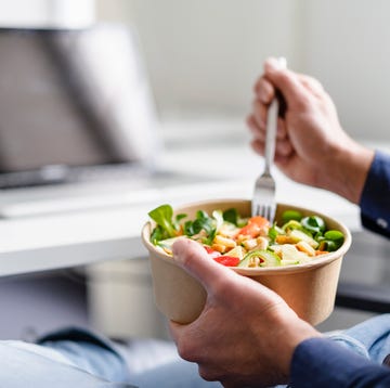 Businessman having salad in office businessman having salad in office