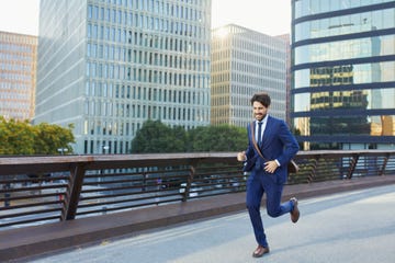 businessman running on city street