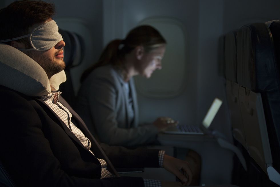 Businessman sleeping on airplane