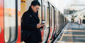 businessman using smart phone on the train platform