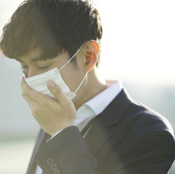 businessman wearing protective mask in city