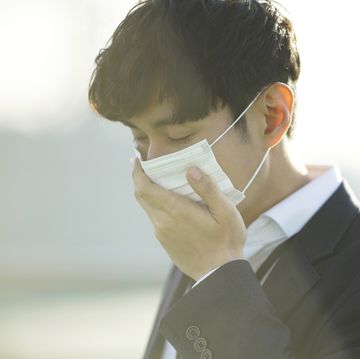 businessman wearing protective mask in city
