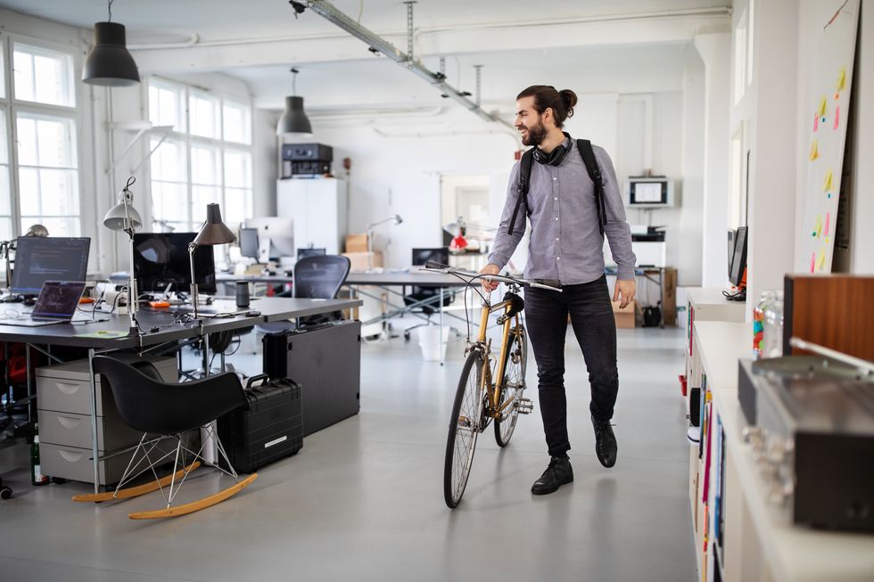businessman with a bicycle in office