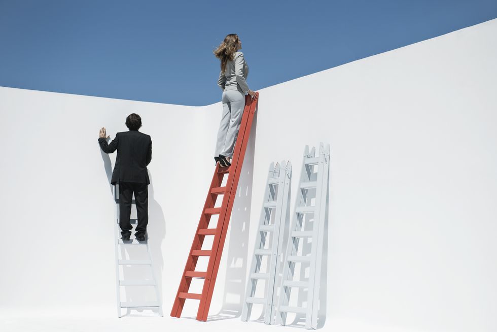 businesswoman at top of ladder