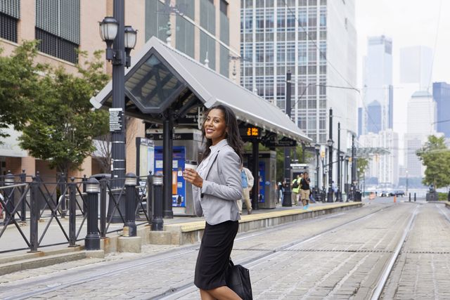 businesswoman crossing light rail tracks