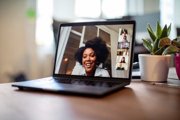 businesswoman having a video call meeting with her team