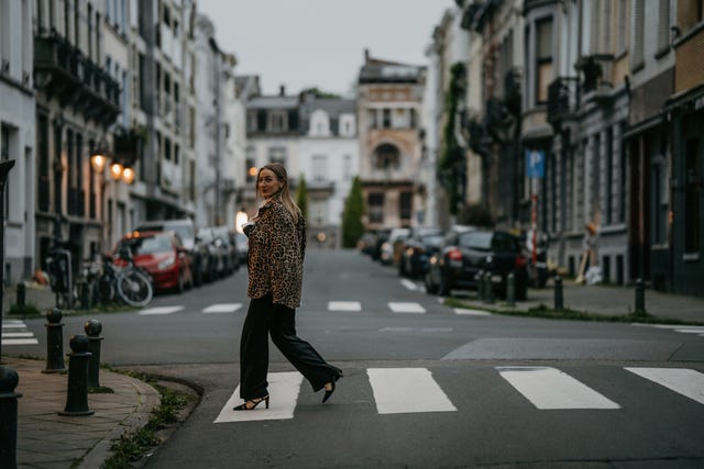 businesswoman in suit crossing street in the city