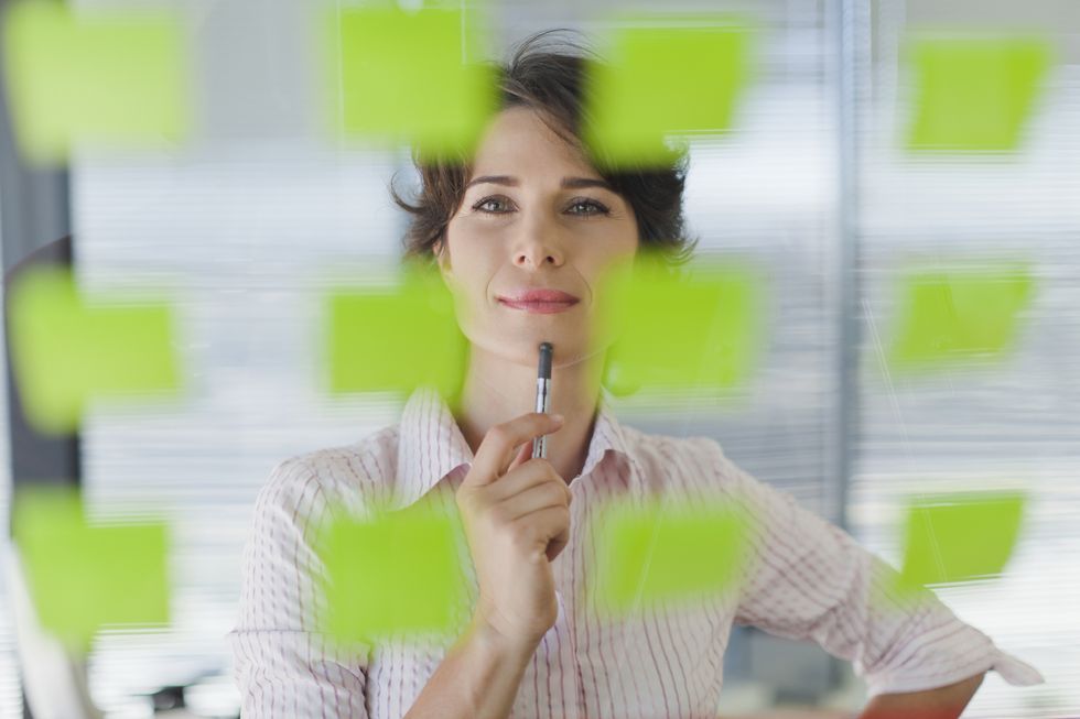 businesswoman reading sticky notes