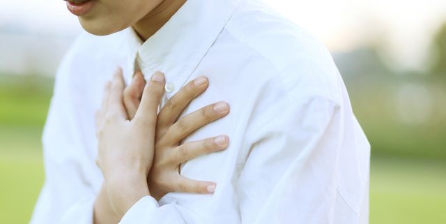 Businesswoman suffering from chest pain outdoors