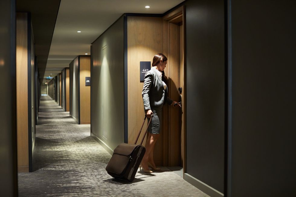 businesswoman with suitcase arriving in hotel