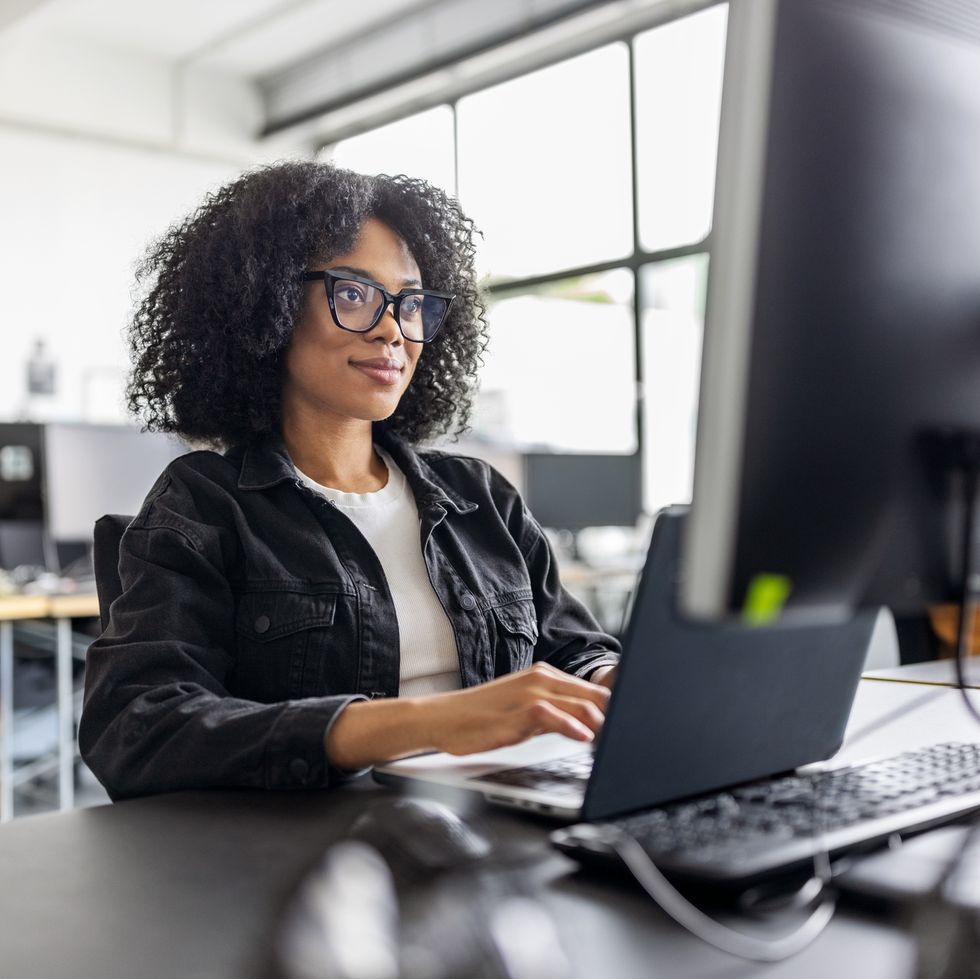 businesswoman working on computer at her desk in office